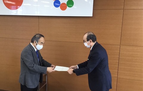 長尾治明委員長が田中市長に答申の受け渡しを行っている写真